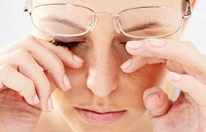 woman rubbing dry eyes