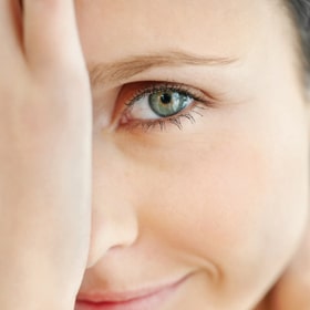 woman looking at camera with one green eye