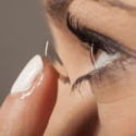 woman putting in a contact lens