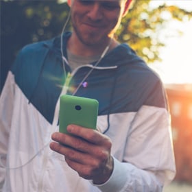 millennial man looking at smartphone
