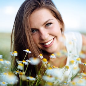 girl smiling by flowers