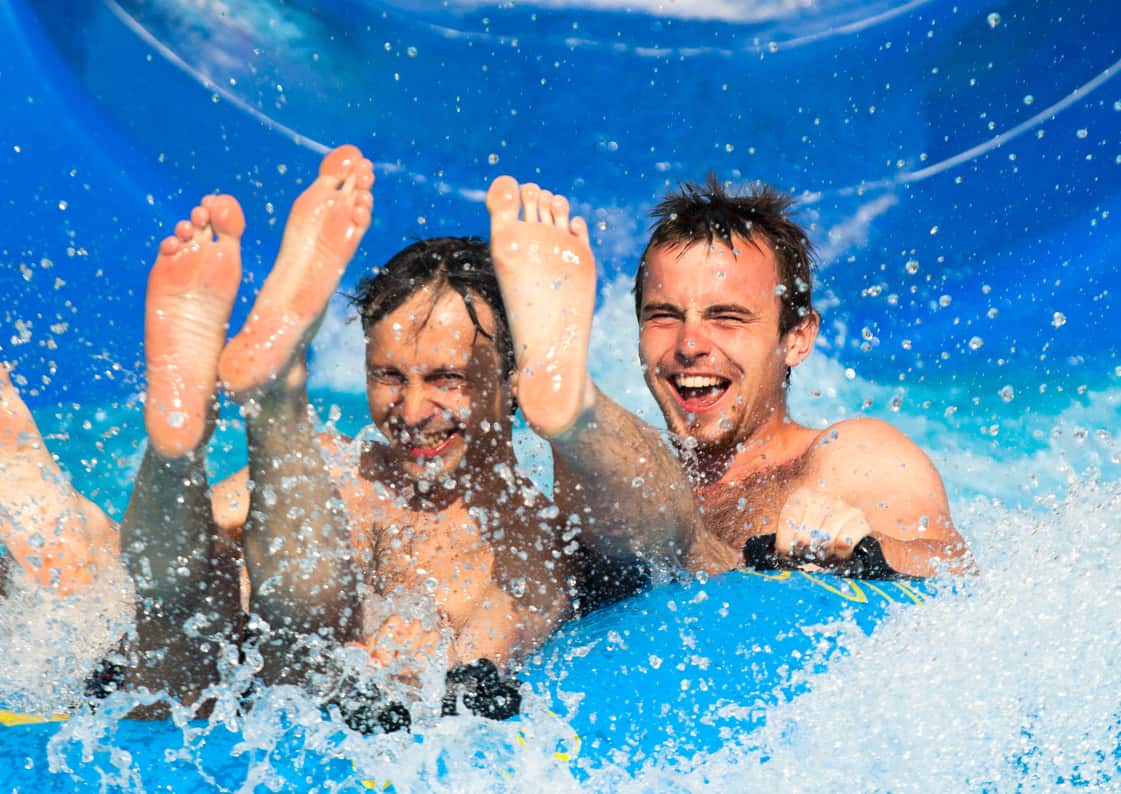 boys going down water slide