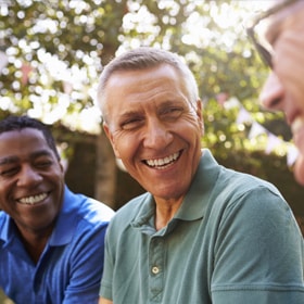 man laughing with friends