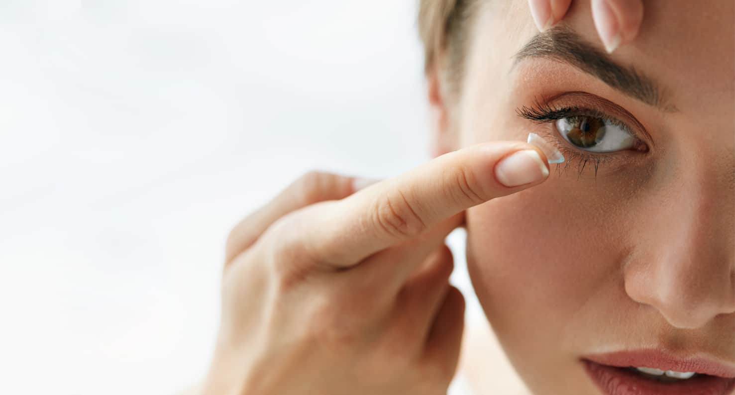 woman putting in contact lens