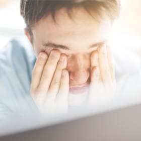person rubbing eyes after lasik