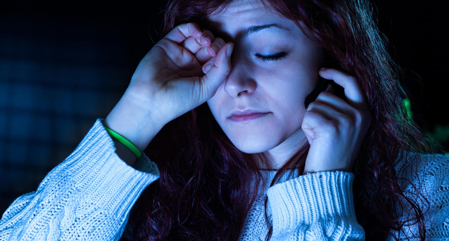 young woman rubbing eyes