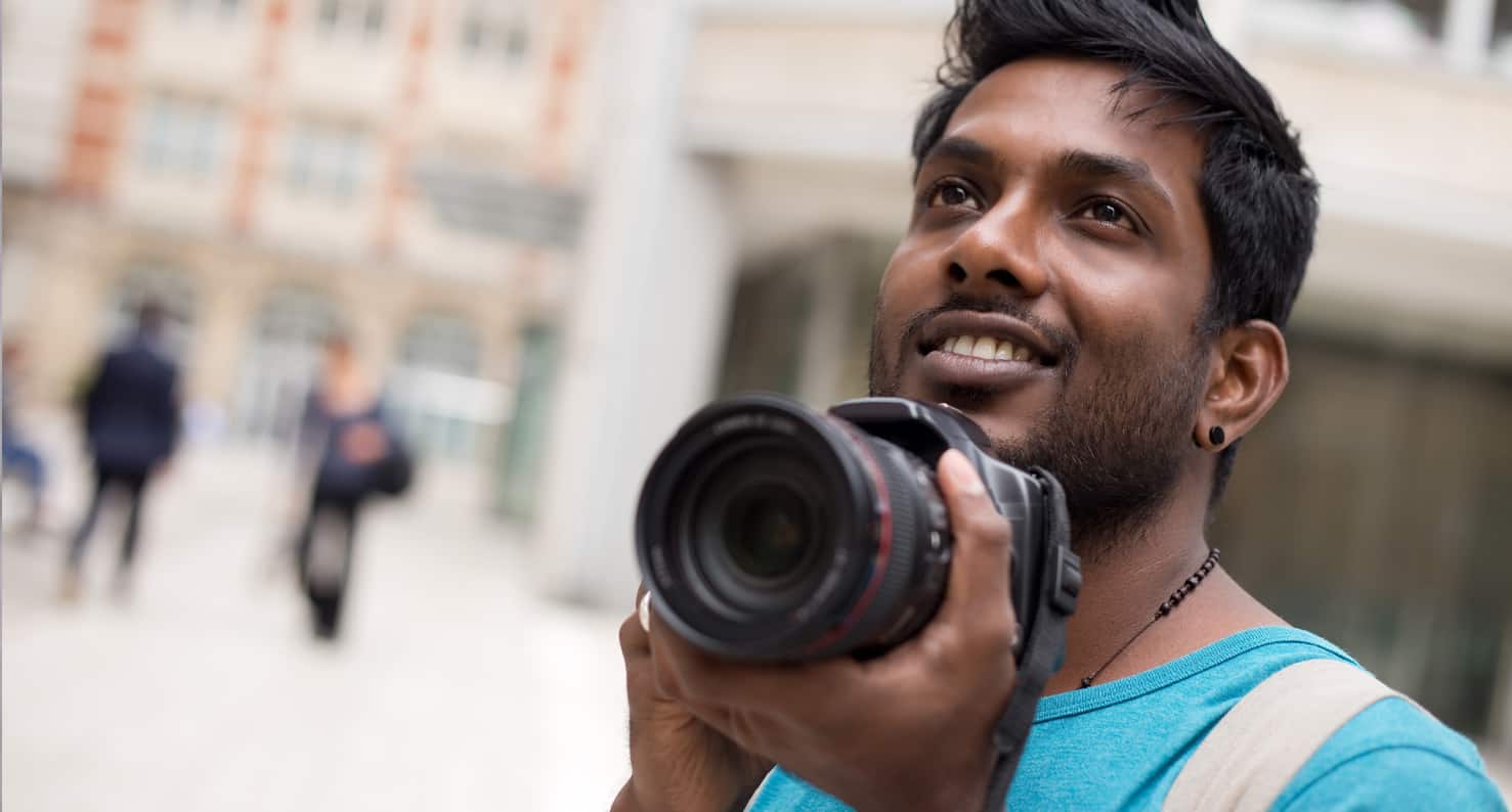 man taking picture with camera