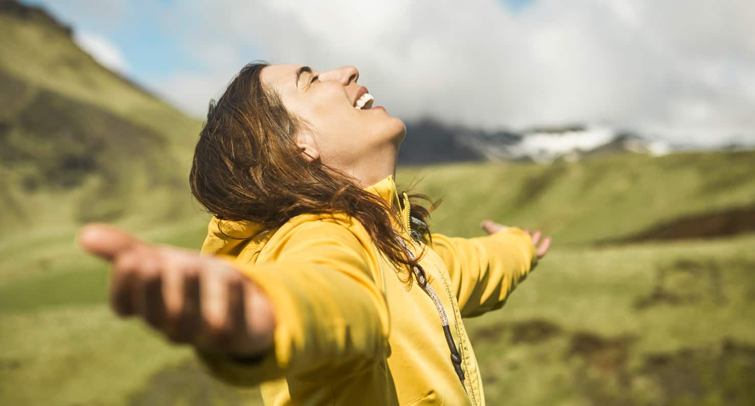 happy woman with arms outstretched