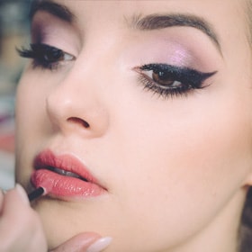 Woman applying lipstick