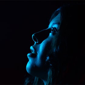 Woman with blue light glow