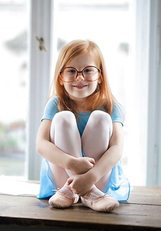 small red headed girl with glasses