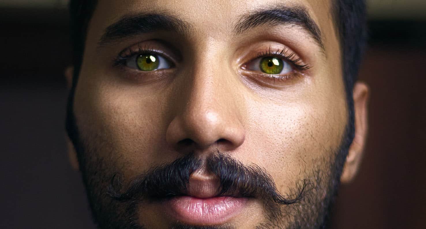 close up of man with green eyes